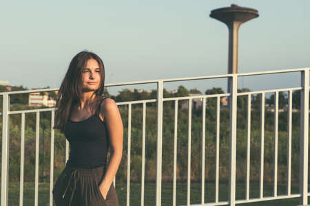 Young beautiful woman with long hair posing in an urban contextの写真素材