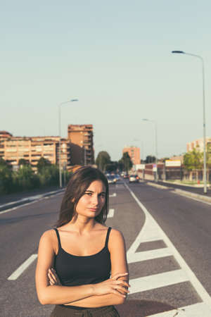Young beautiful woman with long hair posing in an urban contextの写真素材