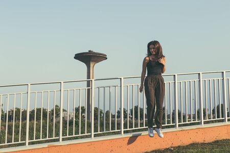 Young beautiful woman with long hair posing in an urban contextの写真素材
