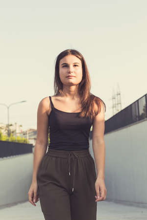 Young beautiful woman with long hair posing in an urban contextの写真素材