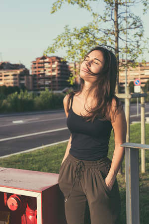Young beautiful woman with long hair posing in an urban contextの写真素材