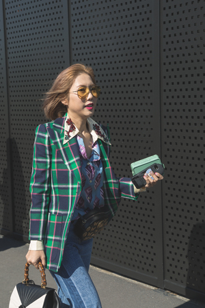 MILAN, ITALY - SEPTEMBER 20: Fashionable woman poses outside Gucci fashion show building during Milan Women's Fashion Week on SEPTEMBER 20, 2017 in Milan.のeditorial素材