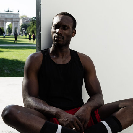 Portrait of an athletic black man posing in a city park. Concept of healthy lifestyle.