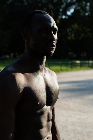Athletic black man posing in a city park. Concept of healthy lifestyle.の写真素材