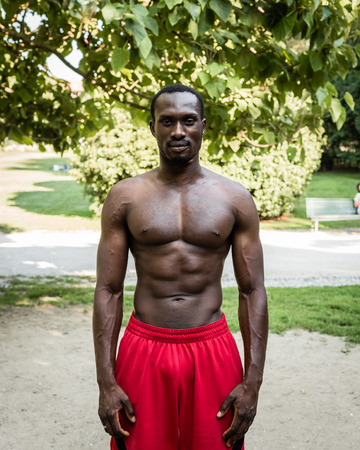 Athletic black man posing in a city park. Concept of healthy lifestyle.の写真素材