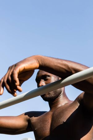 Athletic black man posing in a city park. Concept of healthy lifestyle.の写真素材