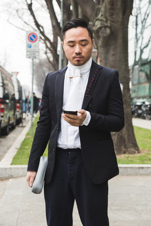 MILAN, ITALY - JANUARY 15: Fashionable man poses outside Armani fashion show during Milan Men's Fashion Week on JANUARY 15, 2018 in Milan.のeditorial素材