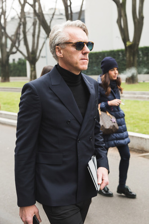 MILAN, ITALY - JANUARY 15: Fashionable man poses outside Armani fashion show during Milan Men's Fashion Week on JANUARY 15, 2018 in Milan.のeditorial素材