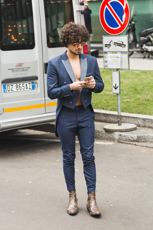 MILAN, ITALY - JANUARY 15: Fashionable man poses outside Armani fashion show during Milan Men's Fashion Week on JANUARY 15, 2018 in Milan.のeditorial素材
