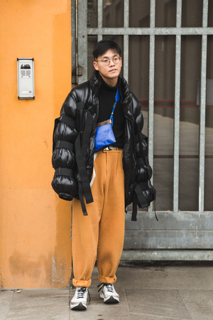 MILAN, ITALY - JANUARY 15: Fashionable man poses outside Armani fashion show during Milan Men's Fashion Week on JANUARY 15, 2018 in Milan.のeditorial素材