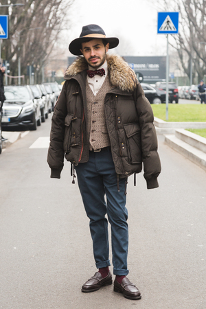 MILAN, ITALY - JANUARY 15: Fashionable man poses outside Armani fashion show during Milan Men's Fashion Week on JANUARY 15, 2018 in Milan.のeditorial素材