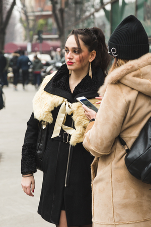 MILAN, ITALY - JANUARY 15: Fashionable woman poses outside Armani fashion show during Milan Men's Fashion Week on JANUARY 15, 2018 in Milan.のeditorial素材