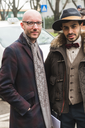 MILAN, ITALY - JANUARY 15: Fashionable men pose outside Armani fashion show during Milan Men's Fashion Week on JANUARY 15, 2018 in Milan.のeditorial素材