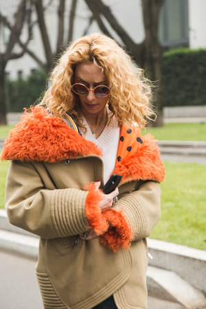 MILAN, ITALY - JANUARY 15: Fashionable woman poses outside Armani fashion show during Milan Men's Fashion Week on JANUARY 15, 2018 in Milan.のeditorial素材