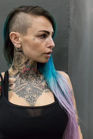 MILAN, iTALY - FEBRUARY 9, 2018: Beautiful tattooed girl poses at Milan Tattoo Convention, international annual event dedicated to tattoos and body painting in Milan, Italy.のeditorial素材