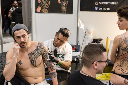 MILAN, iTALY - FEBRUARY 9, 2018: Professional tattooer works at Milan Tattoo Convention, international annual event dedicated to tattoos and body painting in Milan, Italy.のeditorial素材