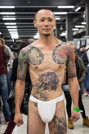MILAN, iTALY - FEBRUARY 9, 2018: Tattooed man poses at Milan Tattoo Convention, international annual event dedicated to tattoos and body painting in Milan, Italy.のeditorial素材