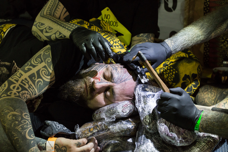 MILAN, iTALY - FEBRUARY 9, 2018: Professional tattooer works at Milan Tattoo Convention, international annual event dedicated to tattoos and body painting in Milan, Italy.のeditorial素材