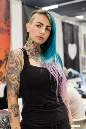 MILAN, iTALY - FEBRUARY 9, 2018: Beautiful tattooed girl poses at Milan Tattoo Convention, international annual event dedicated to tattoos and body painting in Milan, Italy.のeditorial素材