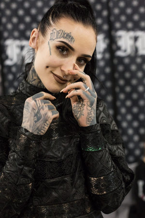 MILAN, iTALY - FEBRUARY 9, 2018: Beautiful tattooed girl poses at Milan Tattoo Convention, international annual event dedicated to tattoos and body painting in Milan, Italy.のeditorial素材