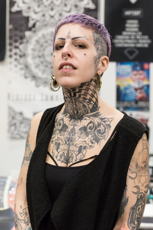 MILAN, iTALY - FEBRUARY 9, 2018: Beautiful tattooed girl poses at Milan Tattoo Convention, international annual event dedicated to tattoos and body painting in Milan, Italy.のeditorial素材