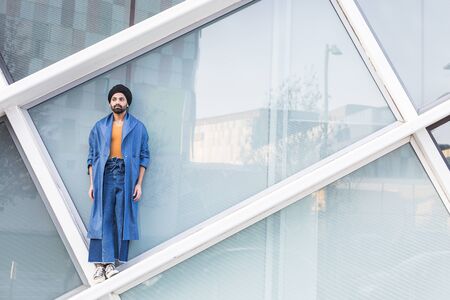 Handsome Indian man posing in an urban context. Street fashion and style.の写真素材