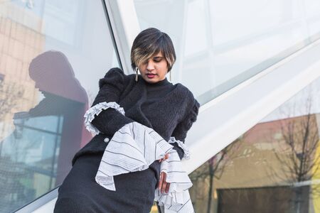 Beautiful young Indian woman posing in an urban context. Street fashion and style.の写真素材