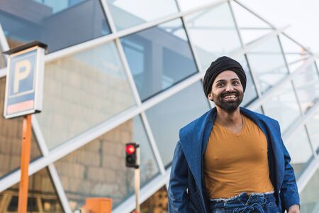 Handsome Indian man posing in an urban context. Street fashion and style.の写真素材