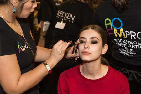 MILAN, ITALY - FEBRUARY 25: Gorgeous model has her make up done in the backstage before Piccione.Piccione show during Milan Women's Fashion Week on FEBRUARY 25, 2018 in Milan.のeditorial素材