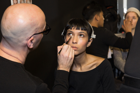 MILAN, ITALY - FEBRUARY 25: Gorgeous model has her make up done in the backstage before Stella Jean show during Milan Women's Fashion Week on FEBRUARY 25, 2018 in Milan.のeditorial素材