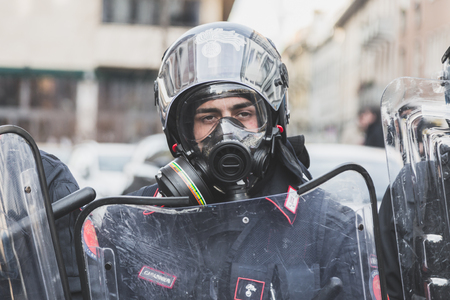 MILAN, ITALY - FEBRUARY 24: Portrait of a riot policeman wearing gas mask during an anti-fascist march in the city streets on FEBRUARY 24, 2018 in Milan.のeditorial素材