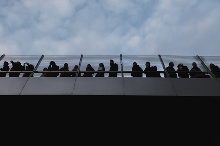 MILAN, ITALY - FEBRUARY 24: People on a bridge watch anti-fascist activists marching in the city streets to protest agaist the extreme right FEBRUARY 24, 2018 in Milan.のeditorial素材