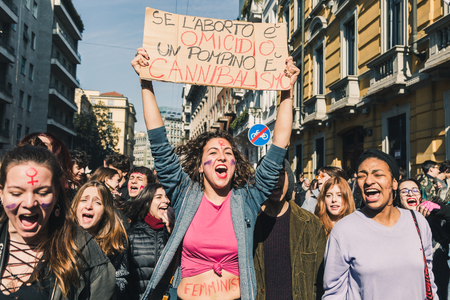 MILAN, ITALY - MARCH 8: Secondary school students celebrate the International Wome's Day on MARCH 8, 2018 in Milan, showing a sign that reads If abortion is homicide a blowjob is cannibalism.のeditorial素材