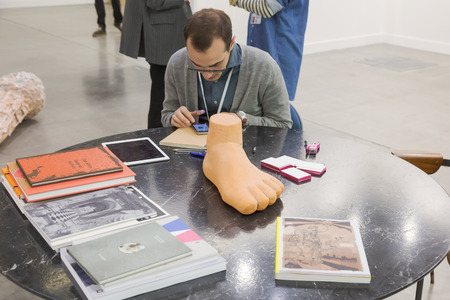 MILAN, ITALY - APRIL 13: Exhibitor is seen in his stand at Miart, international exhibition of modern and contemporary art on APRIL 13, 2018 in Milan.のeditorial素材