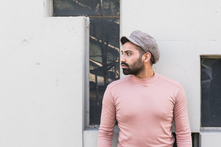 Handsome Indian man posing in an urban context. Street fashion and style.の写真素材