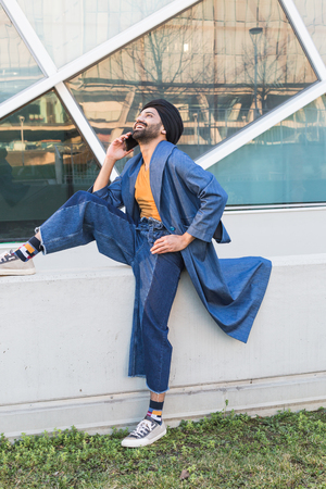 Handsome Indian man talking on phone in an urban context. Street fashion and style.の写真素材