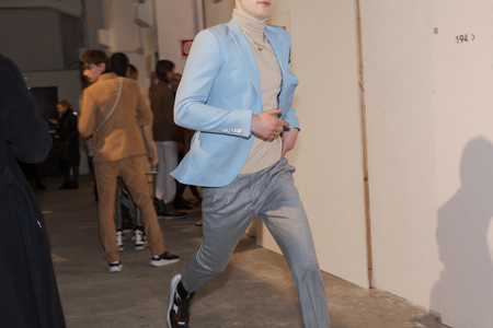 MILAN, ITALY - JANUARY 12: Beautiful model runs in the backstage just before Miguel Vieira show during Milan Men's Fashion Week on JANUARY 12, 2019 in Milan.のeditorial素材