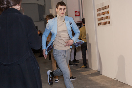 MILAN, ITALY - JANUARY 12: Beautiful model runs in the backstage just before Miguel Vieira show during Milan Men's Fashion Week on JANUARY 12, 2019 in Milan.のeditorial素材