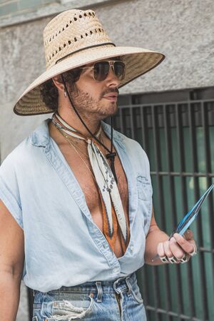 MILAN, ITALY - JUNE 15: Fashionable man poses outside Armani fashion show during Milan Men's Fashion Week on JUNE 15, 2019 in Milan.のeditorial素材