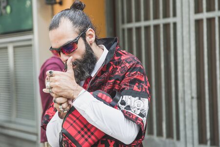 MILAN, ITALY - JUNE 15: Fashionable man poses outside Armani fashion show during Milan Men's Fashion Week on JUNE 15, 2019 in Milan.のeditorial素材