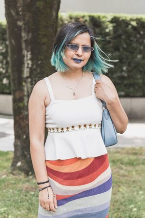 MILAN, ITALY - JUNE 15: Fashionable woman poses outside Armani fashion show during Milan Men's Fashion Week on JUNE 15, 2019 in Milan.のeditorial素材