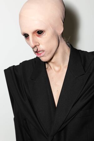 MILAN, ITALY - JANUARY 12: Model with eyeball tattoo poses in the backstage just before Han Kjobenhavn show during Milan Men's Fashion Week on JANUARY 12, 2020 in Milan.のeditorial素材
