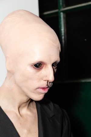 MILAN, ITALY - JANUARY 12: Model with eyeball tattoo poses in the backstage just before Han...