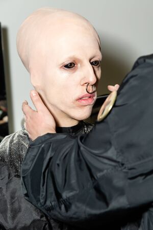 MILAN, ITALY - JANUARY 12: Model with eyeball tattoo is seen at make up just before Han Kjobenhavn show during Milan Men's Fashion Week on JANUARY 12, 2020 in Milan.のeditorial素材