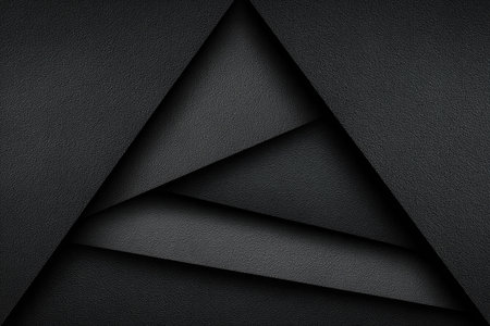 Geometric composition featuring layered, textured paper in shades of gray, forming a triangleの素材