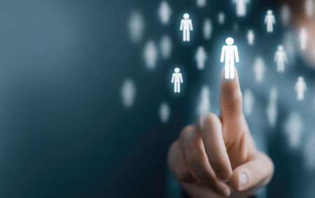 A finger touches a glowing person icon amidst a sea of similar figuresの素材