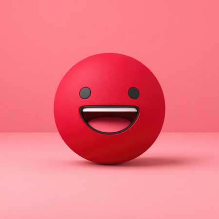 A vibrant red spherical emoji with a smiling mouth and simple black eyes on a pink backdropの素材