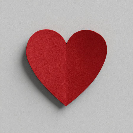 A bold red heart-shaped cutout casting a shadow on a textured, light gray backgroundの素材