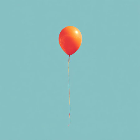 A vibrant orange balloon floats against a bright, clear teal sky, held by a thin stringの素材