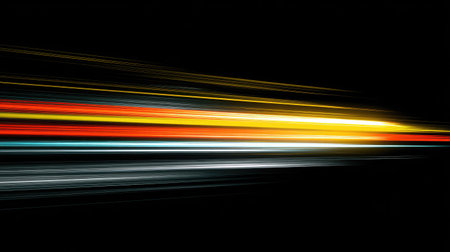 This image features vibrant light trails in various colors stretching horizontally across a stark black backdrop. The streaks exhibit a dynamic movement, creating a sense of speed and energy. The composition emphasizes lines and color, suitable for artistic, design, or conceptual applications.の素材